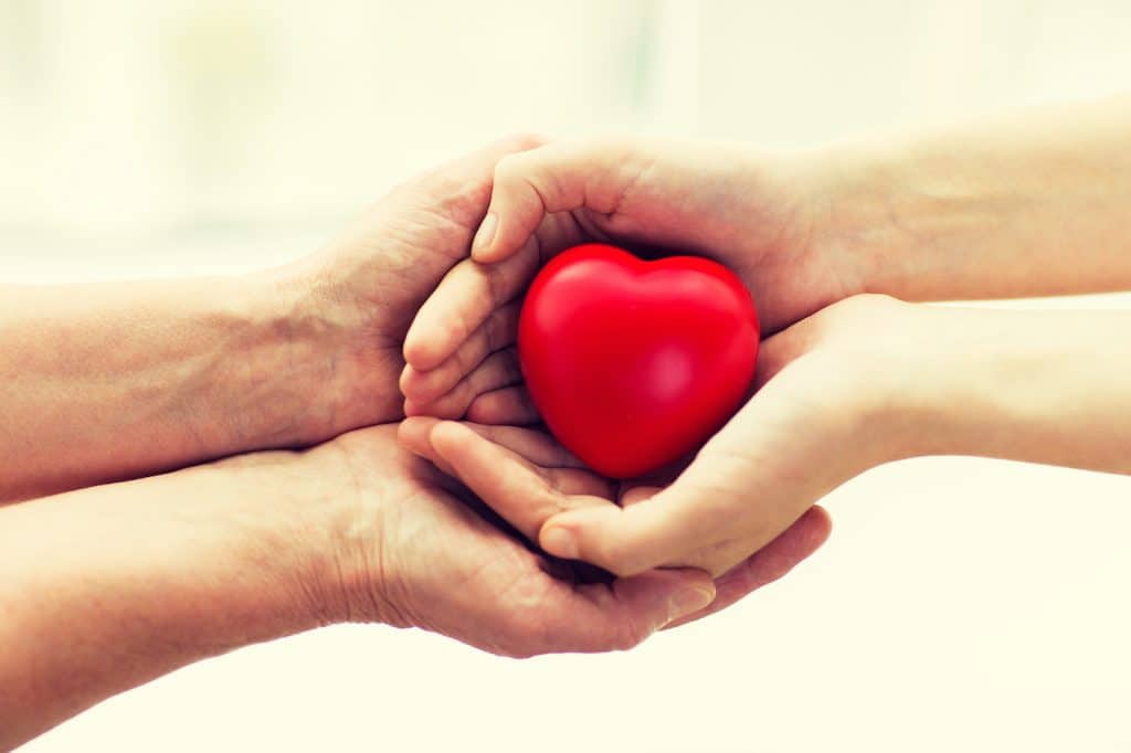 seniors hands around a hearth - heart health