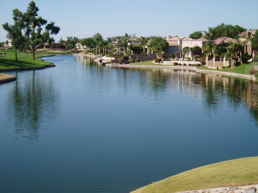 Homes on a beautiful blue lake in a golf course community.