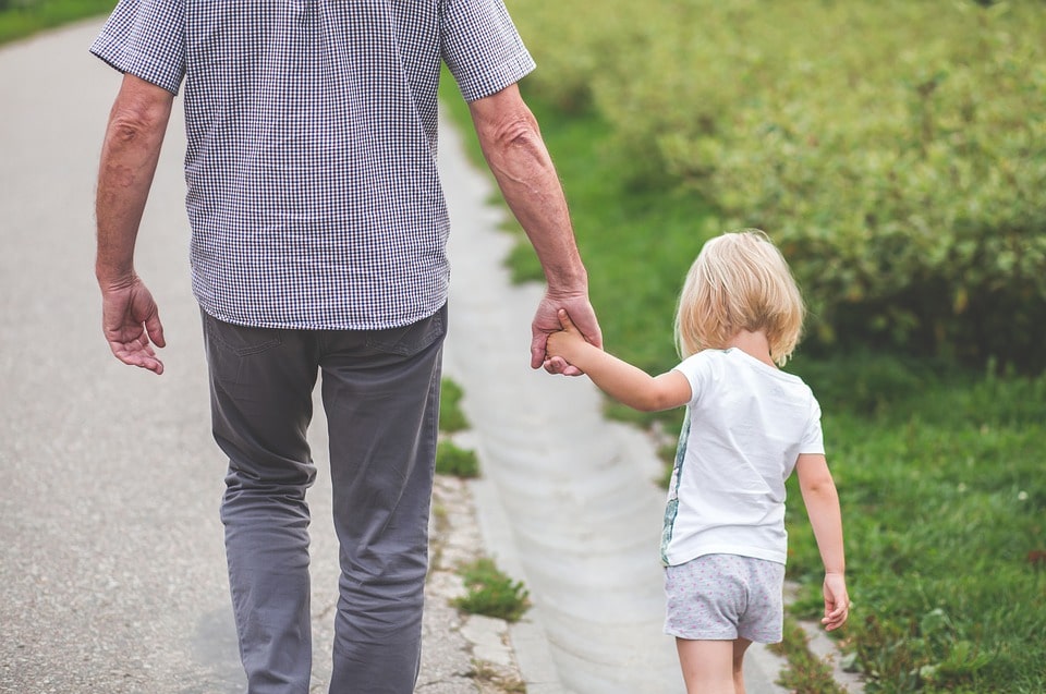 Healthy lifestyle advice for people over 50. Photo of man walking with small child.