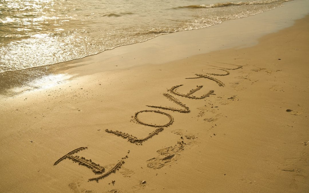 Quotes about love. Photo with "I Love You" written in the sand.
