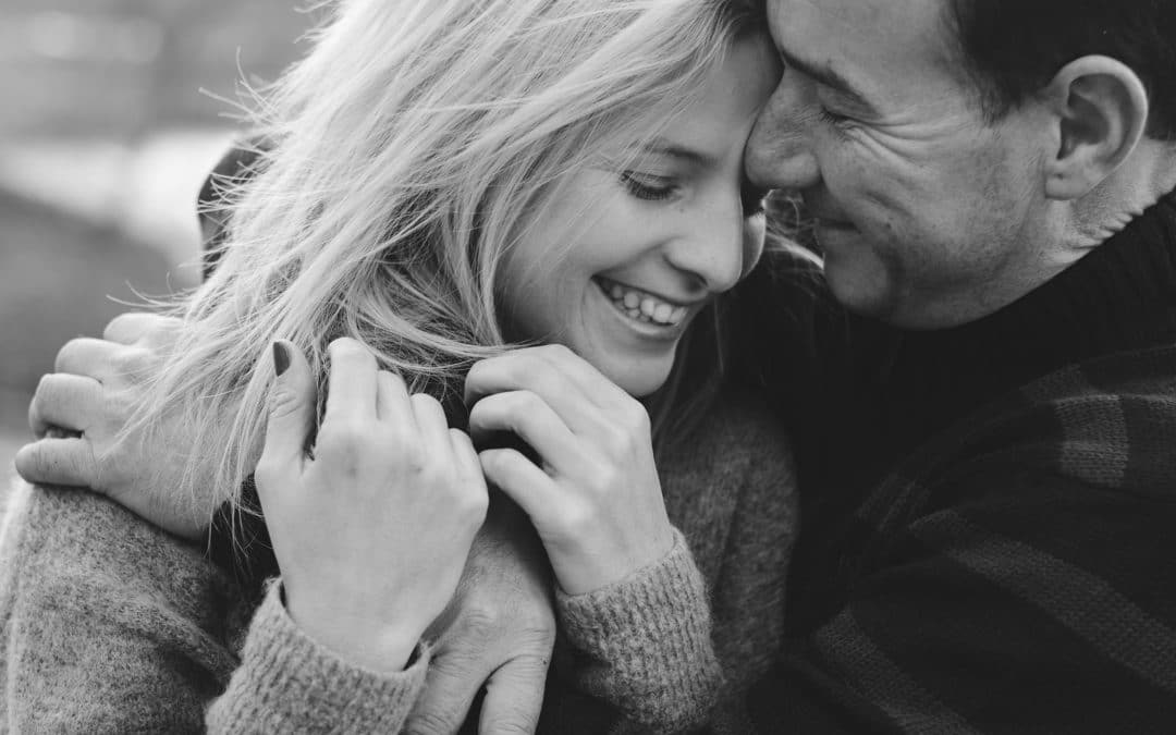 Young couple in love hug each other. Smiling couple in love outdoors. Couple face to face on Valentine's Day
